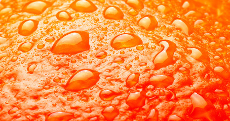 Ripe Orange Background texture with waterdrops macro studio shot