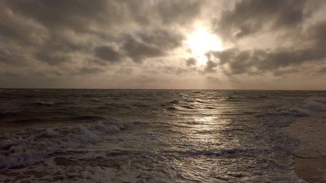 Amazing golden hour panoramic sunset at sea with dramatic sky and beautiful light between cirrus clouds