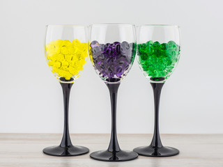 creating an intimate atmosphere, room decoration: three glasses filled with hydrogel balls of different colors