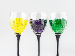 creating an intimate atmosphere, room decoration: three glasses filled with hydrogel balls of different colors, close, in a row