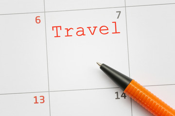 Orange pen that points to a travel text.