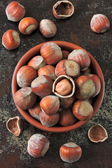 Fresh hazelnuts in the shell in a bowl.