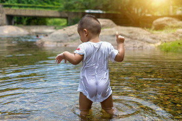 Buttocks of the child standing in the water.