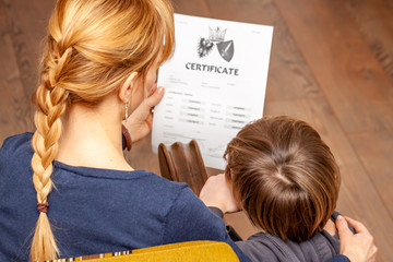 Mother comforting son despite the bad school certificate