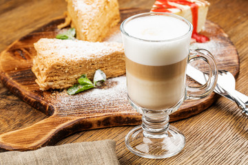 A glass of delicious latte on wooden table.