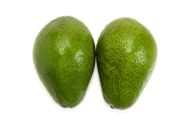 Two whole green avocado fruits on a white background