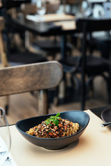 Capellini Cold Pasta with Hikiji Seaweed,  Chilled Lobster and Truffle Essence, Served in black bowl.