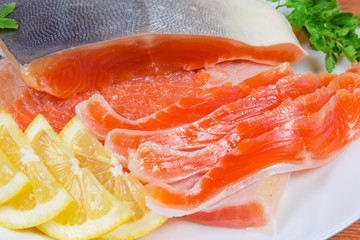 Partly sliced salted arctic char on a dish close-up