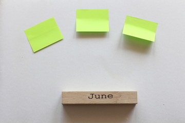 plans for June. three color stickers and a wooden block with the inscription June