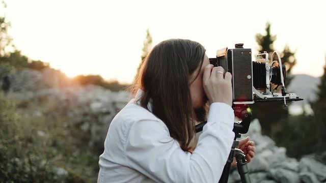 Photographer customizes large format camera before shooting