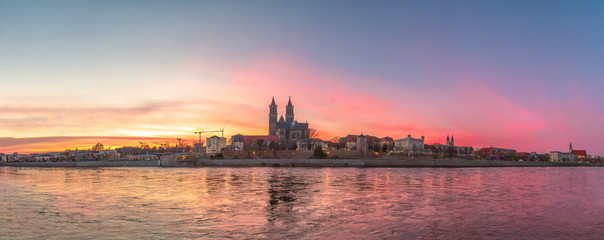 Panoramic view of bloody sunset in front of cathedral in Magdeburg, Germany, Spring, red cloudy sky