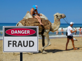 Sign dangerous scammers on the beach and camel riding children.