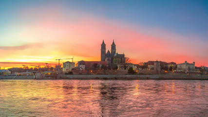Panoramic view of bloody sunset in front of cathedral in Magdeburg, Germany, Spring, red cloudy sky