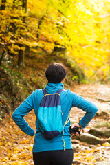 woman in trekking hiking  with backpack in autumn forest of Geres , Portugal