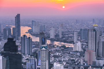 View of Bangkok skyline and skyscraper Panorama over Chao Phraya River Bangkok Thailand at sunset.