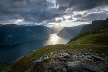 Beautiful sun beam in the Aurlandfjord from Prest viewpoint in stunning mountain scenery Norway