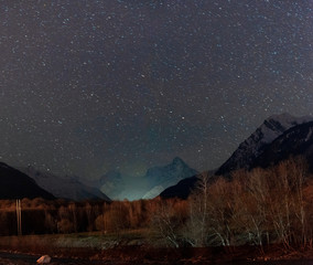 Fototapeta na wymiar Dombay mountains at night under a starry sky, Karachay-Cherkessia Russia