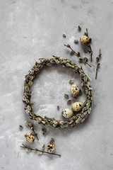 Quail eggs and pussy willow wreath as a symbols of spring and Easter