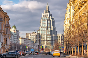 moscow city russia street historical urban view of old and new building architecture with road traffic people walking on beautiful spring sunset light background evening downtown cityscape landmark
