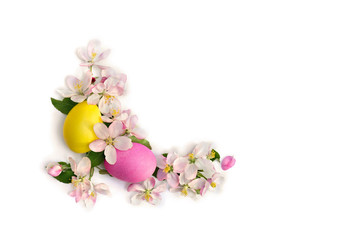 Easter decoration. Pink flowers apple tree and colored easter eggs on white background with space for text. Top view, flat lay