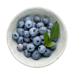 Fresh ripe blueberry berries in bowl isolated on white background. Top view. Flat lay.