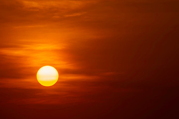 The golden light of the sun and clouds in the sky.