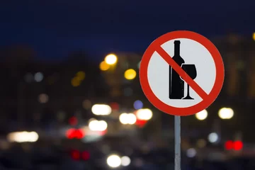Foto auf Acrylglas the Sign the prohibition of alcohol and the night road with cars © Stanislav