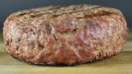 Ingredients for a burger, close-up ready-made cutlet laid out on a wooden board