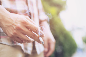 man smoking a cigarette. Cigarette smoke spread. 