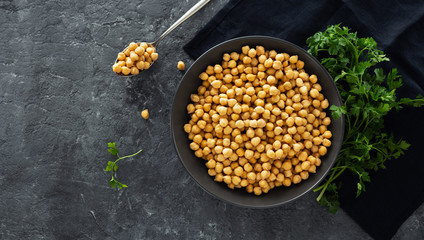 Cooking chickpeas bowl dark stone background top view