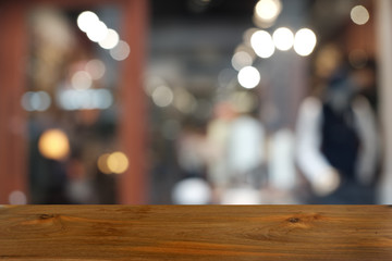 Empty dark wooden table in front of abstract blurred bokeh background of restaurant . can be used for display or montage your products.Mock up for space.