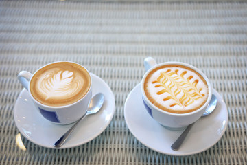 hot caramel macchiato and latte coffee drink put on table in cafe