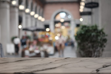 Empty rock table in front of abstract blurred background of forest .
