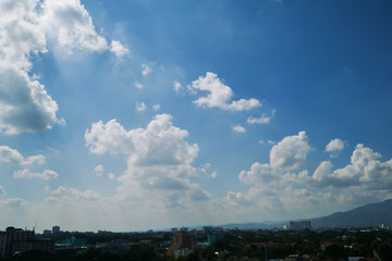 Fototapeta na wymiar white cloud on clear blue sky above the town