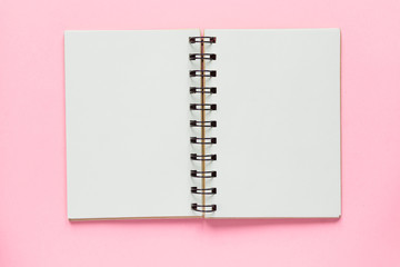 Clean spiral note book for notes and messages on pastel pink background. Minimal business flat lay