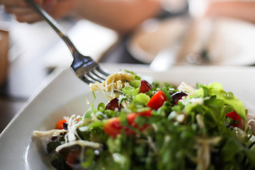 Delicious salad with chicken, nuts, egg and vegetables Fresh salad with chicken breast.