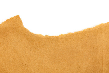 An overhead photo of a piece of torn brown kraft paper on a white background with a place for text