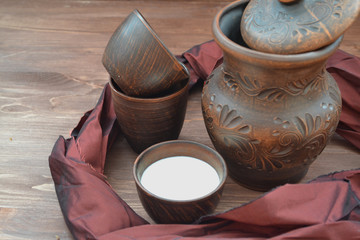 Healthy goat milk in rustic pottery. Lifestyle detox concept.