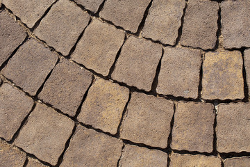Closeup view of texture of brown paving slabs at side walk of city. Horizontal color photography.