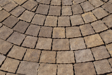 Closeup view of texture of brown paving stabs at sidewalk of city. Horizontal color photography.