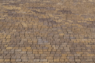 Closeup view of texture of brown paving stabs at sidewalk of city. Horizontal color photography.