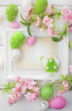 photo frame with easter eggs and cherry blossom flowers