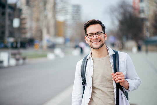 Portrait Of A Smiling Casual Man In Urban Background.