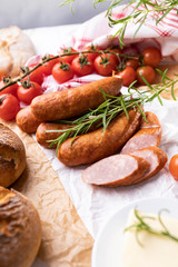 Thin sausage in composition with vegetables and herbs