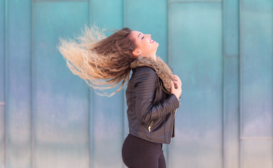 Beautiful young woman play her hair