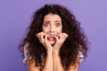 Close up photo beautiful her she lady unexpected epic fail arms hands fingers near mouth bite teeth eyes full fear oh no expression wear casual white t-shirt clothes isolated violet purple background