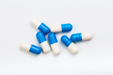 set of blue and white  capsules on a white background