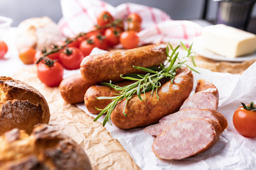Smoked sausage, thin sausage in composition with vegetables and herbs