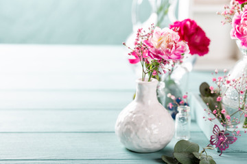 Bouquet of pink carnation on light turquoise wooden background