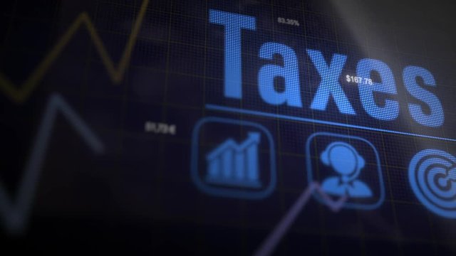 Taxes business concept on a flashing computer monitor with moving graphs and data.